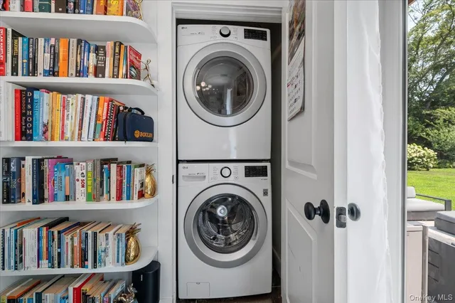 a view of a bedroom with a book shelf and a shelf with wooden floor