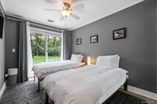 a bed sitting in a bedroom next to a window