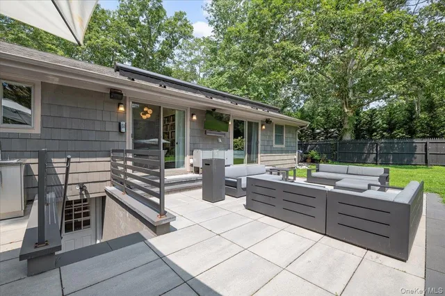 a view of backyard with outdoor seating and green space