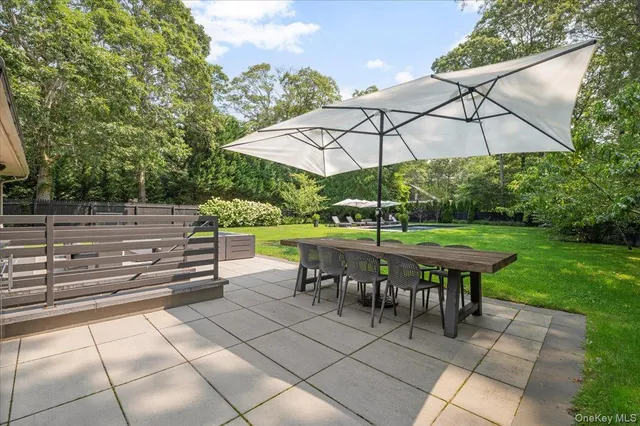 an outdoor view of patio with umbrella
