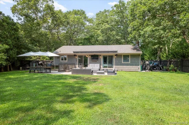 a view of a house with a yard table and chairs