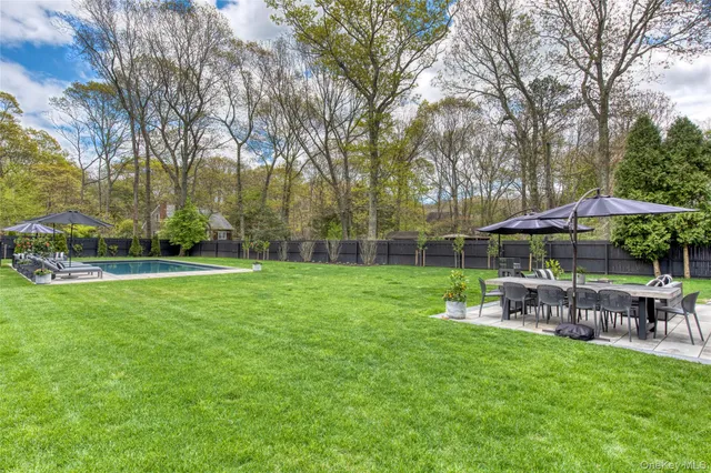a view of backyard with seating space and trees