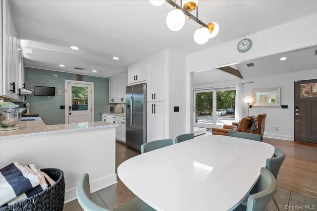 a large white kitchen with a table and chairs