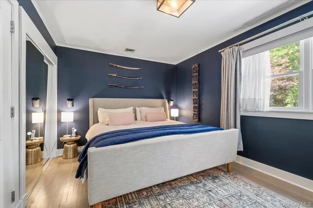 a bed sitting in a bedroom next to a window