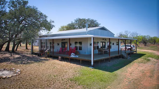 a view of a house with a yard balcony and sitting area