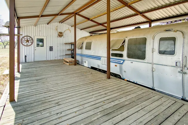 a view of a kitchen with stainless steel appliances granite countertop a stove and a dining table