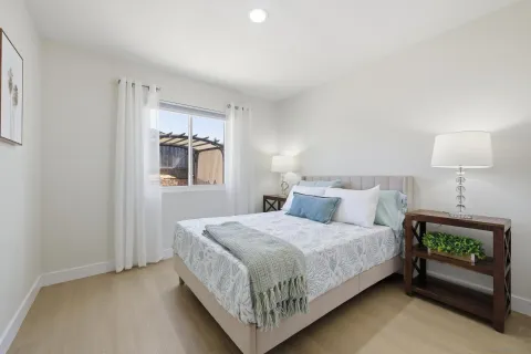 a bedroom with a bed and a night stand