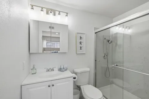 a bathroom with a sink toilet and shower
