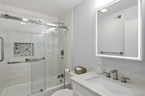a bathroom with a sink toilet and shower
