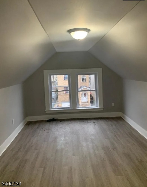543 Court Street Elizabeth Port, NJ 07206 - Photo 5 of 7 an empty room with wooden floor and windows