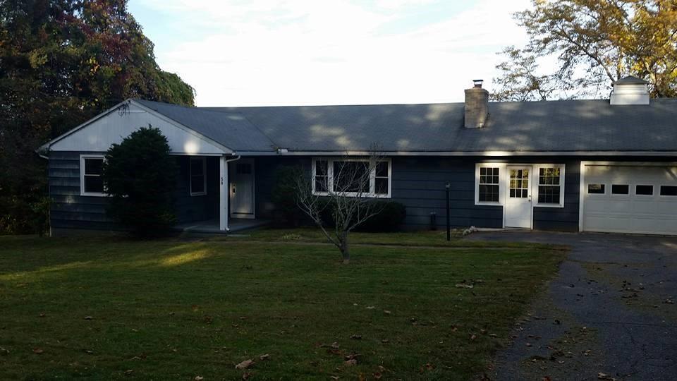 a front view of a house with a garden