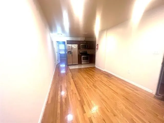 a view of a kitchen from the hallway