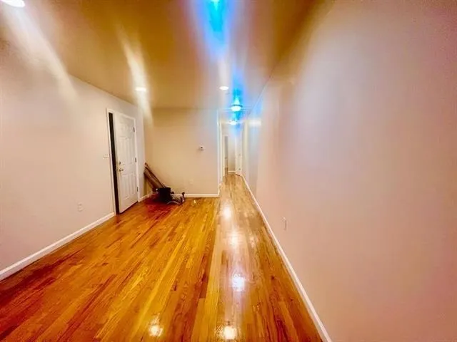 a view of a room with wooden floor