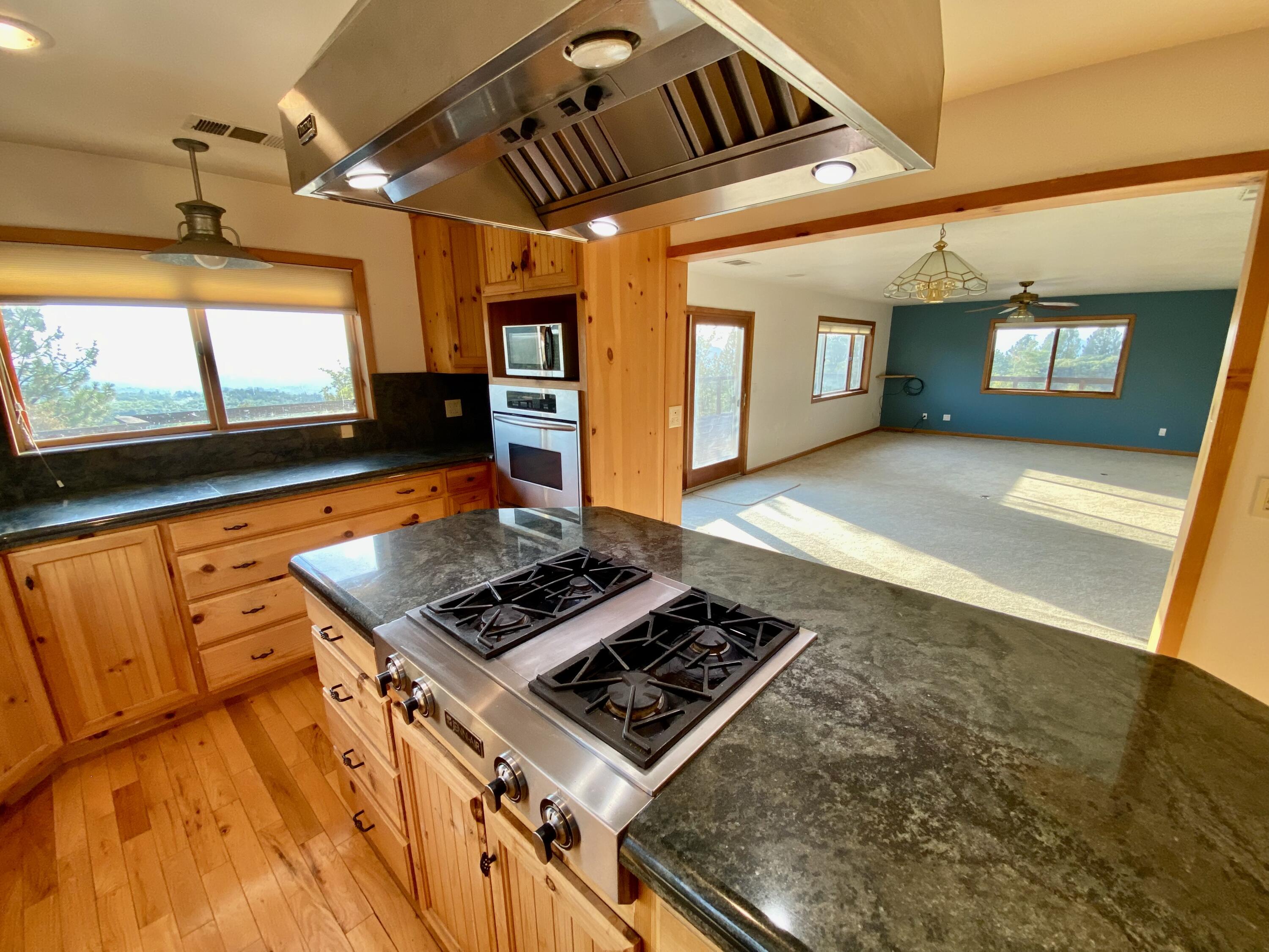 30503 Terry Mill Road Montgomery Creek, CA 96065 - Photo 13 of 75 a living room with a flat screen tv and a fireplace