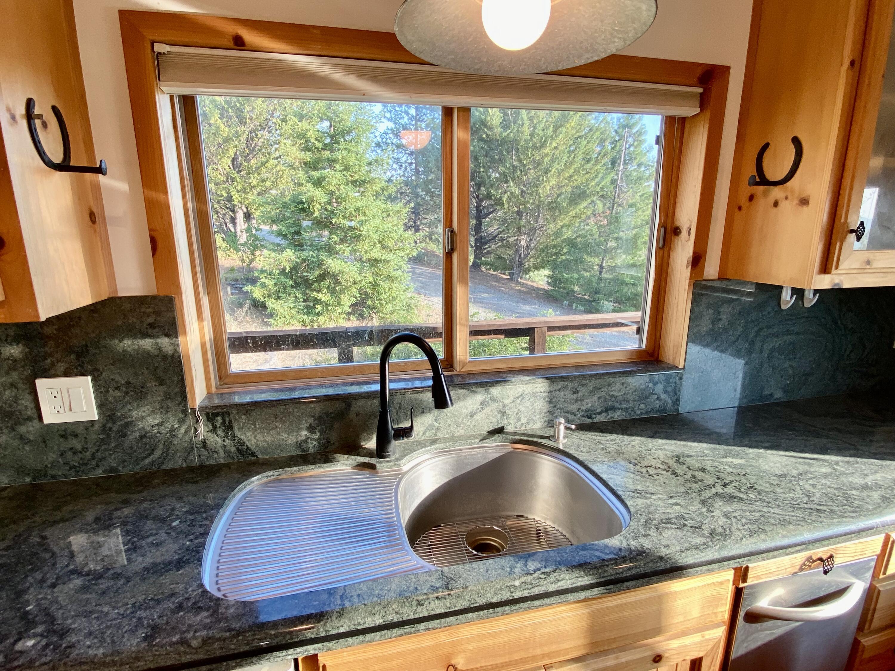 30503 Terry Mill Road Montgomery Creek, CA 96065 - Photo 14 of 75 a kitchen with granite countertop a sink a stove and a wooden floor
