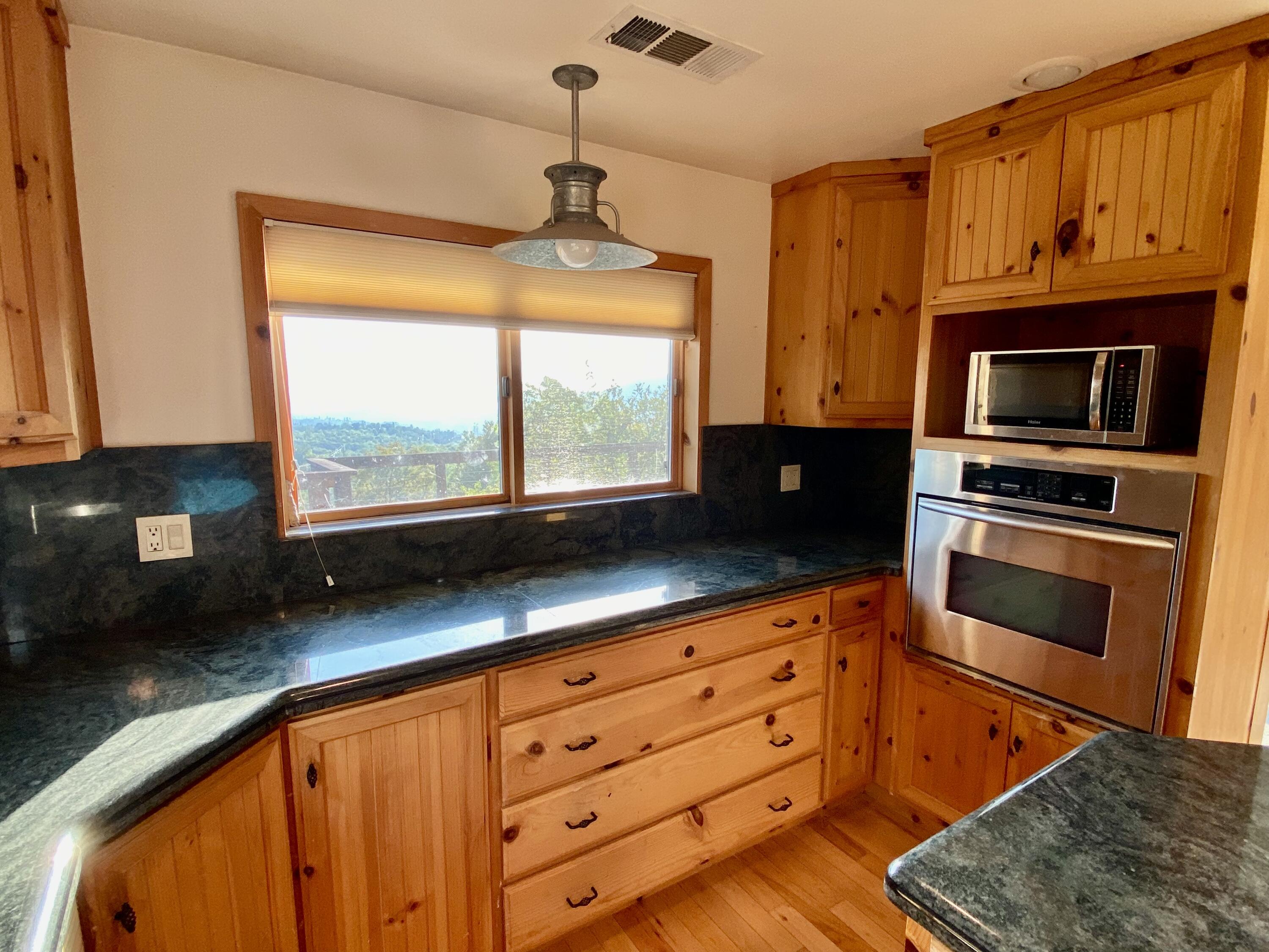30503 Terry Mill Road Montgomery Creek, CA 96065 - Photo 15 of 75 a kitchen with stainless steel appliances granite countertop a stove a sink and a microwave