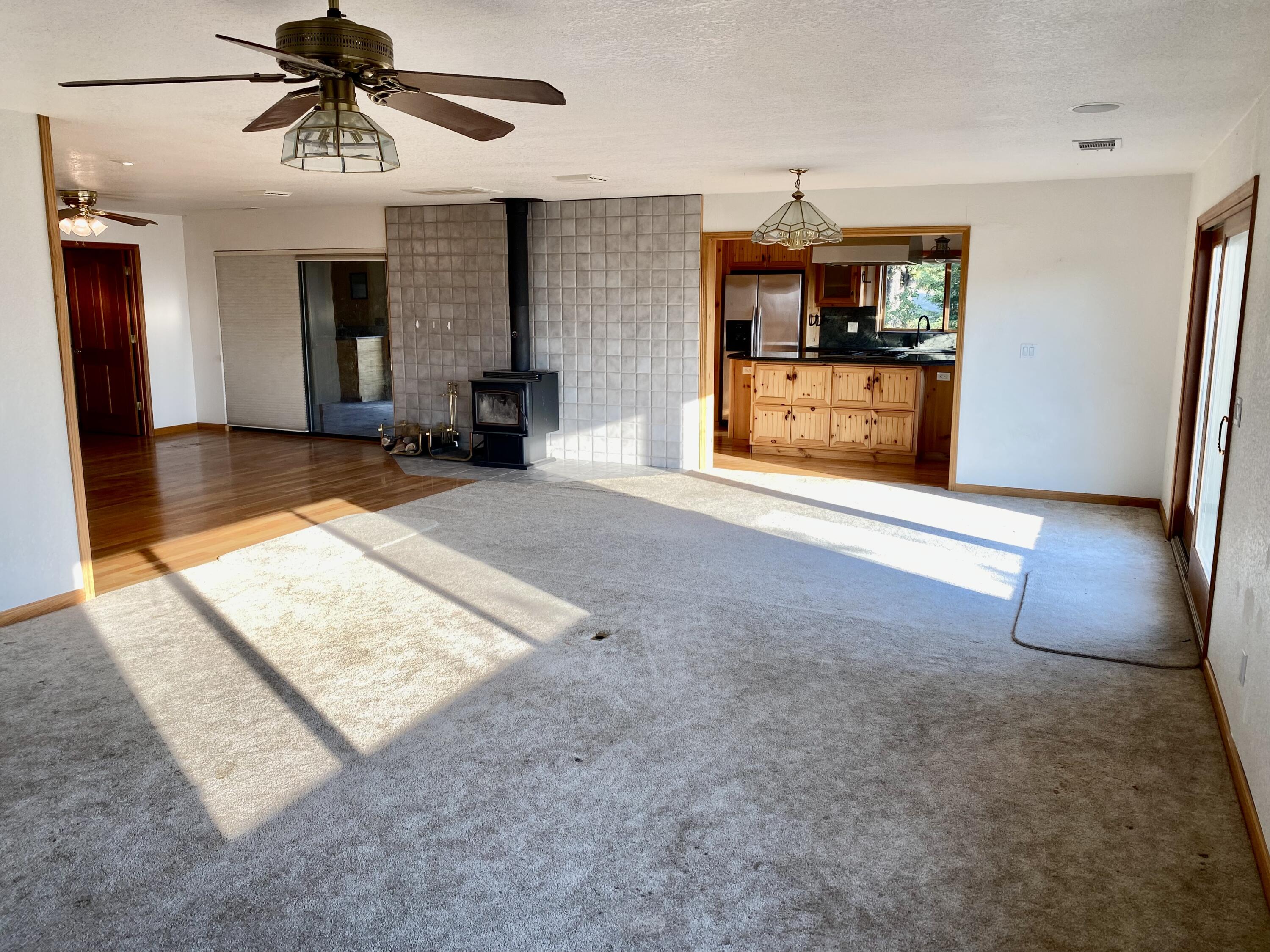 30503 Terry Mill Road Montgomery Creek, CA 96065 - Photo 21 of 75 a view of a hallway with a dining table and chandelier