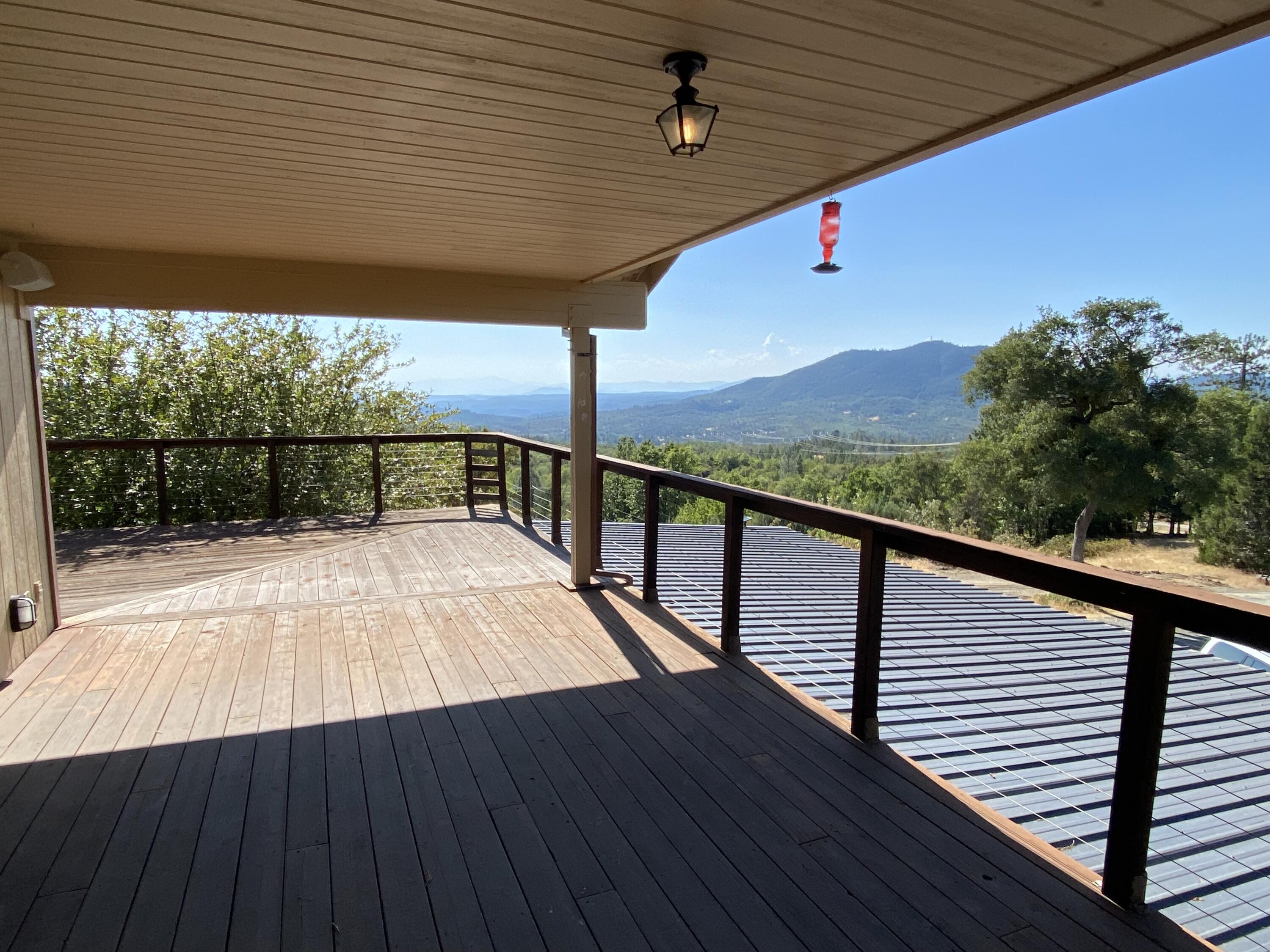 30503 Terry Mill Road Montgomery Creek, CA 96065 - Photo 37 of 75 a view of balcony with wooden floor and fence