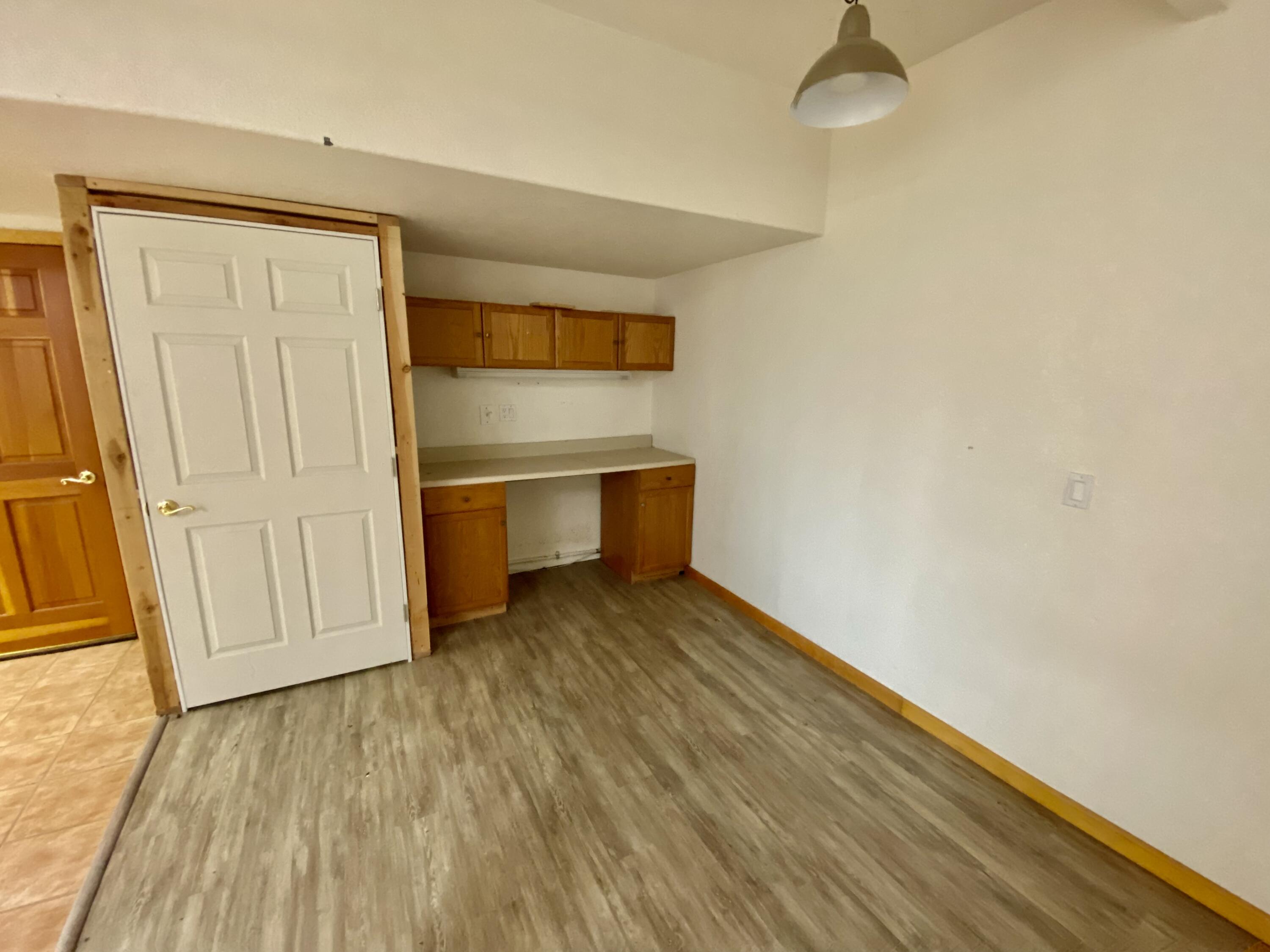 30503 Terry Mill Road Montgomery Creek, CA 96065 - Photo 56 of 75 an empty room with wooden floor and windows