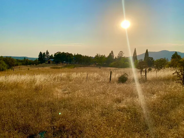 a view of balcony with wooden floor and fence
