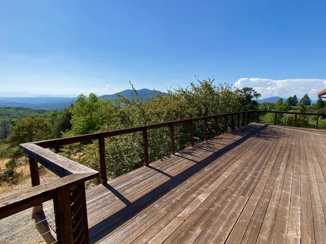 a view of a balcony with wooden floor and outdoor space