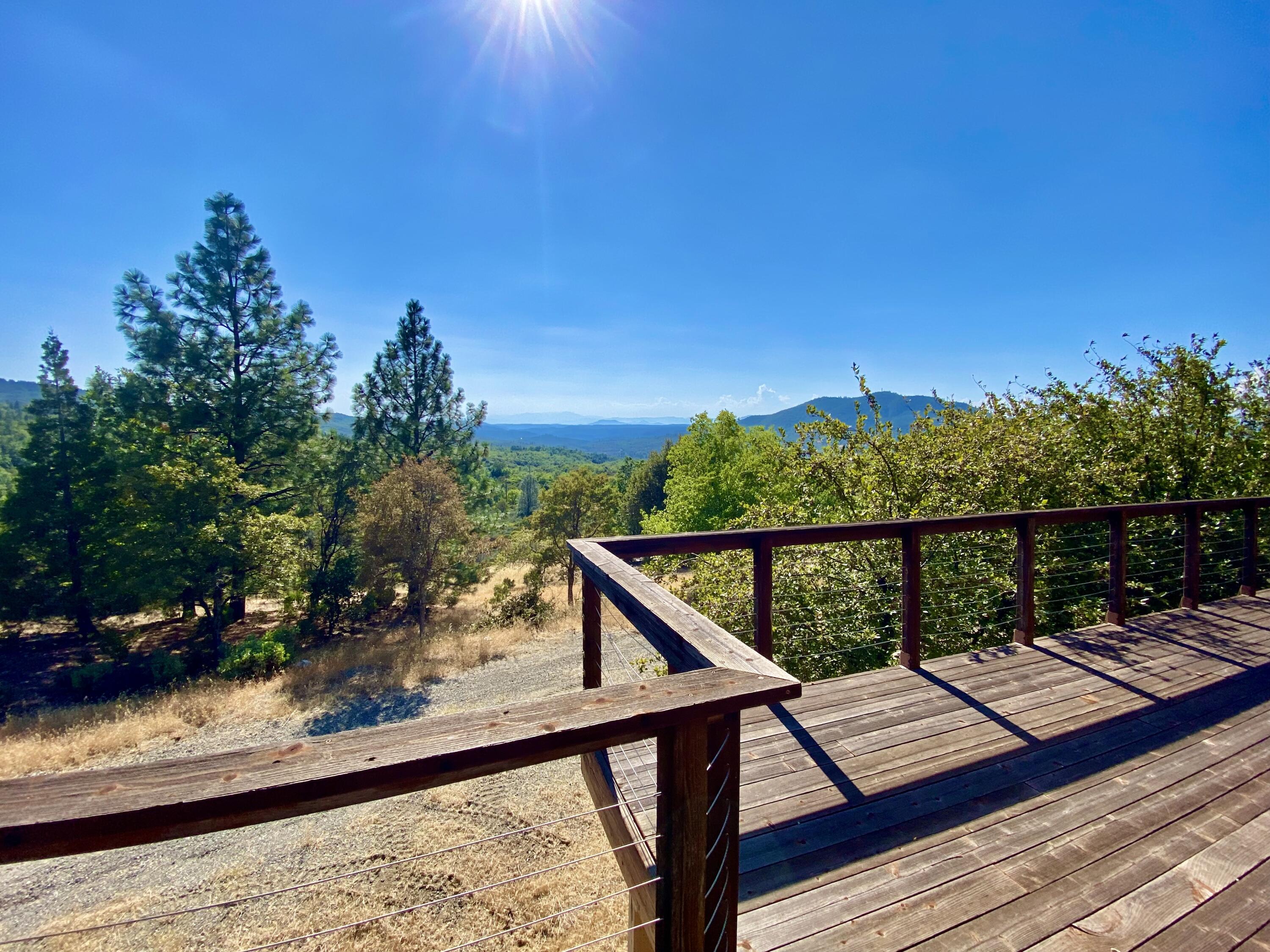 30503 Terry Mill Road Montgomery Creek, CA 96065 - Photo 8 of 75 a view of a balcony with wooden floor and outdoor space