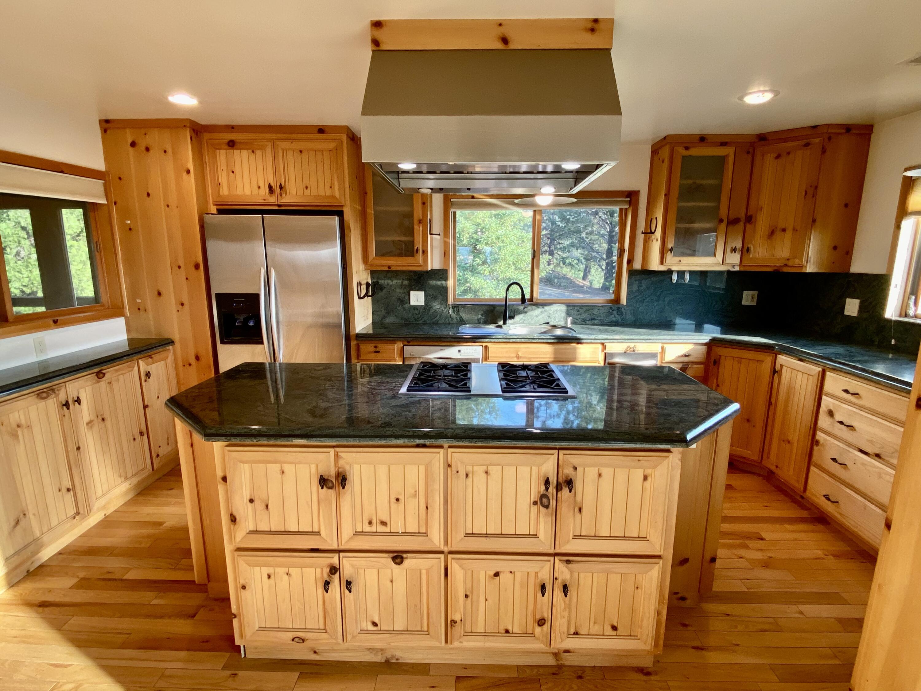 30503 Terry Mill Road Montgomery Creek, CA 96065 - Photo 9 of 75 a kitchen with granite countertop a sink and cabinets