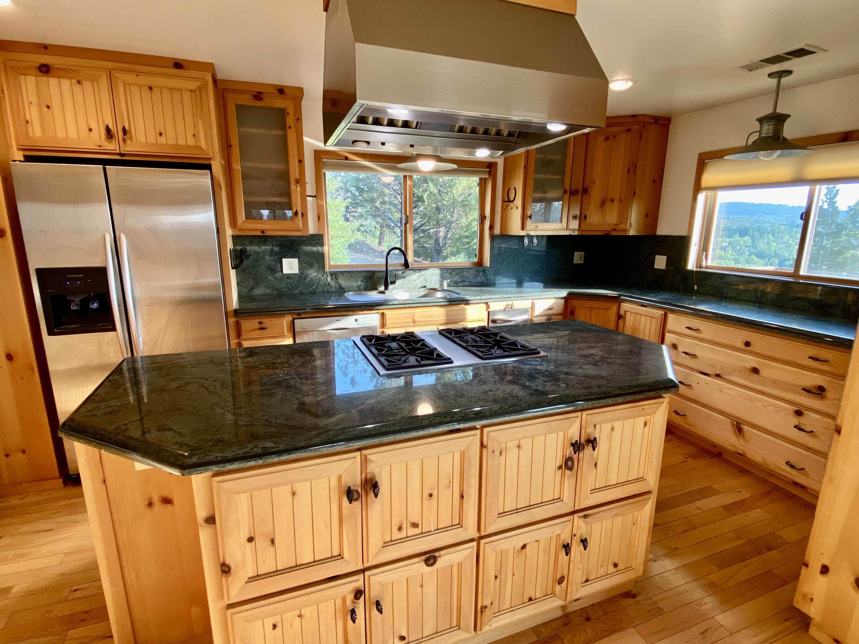 30503 Terry Mill Road Montgomery Creek, CA 96065 - Photo 10 of 75 a kitchen with stainless steel appliances granite countertop a sink a stove and a wooden floors