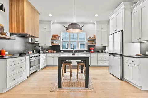 a view of a living room with a couch and potted plant