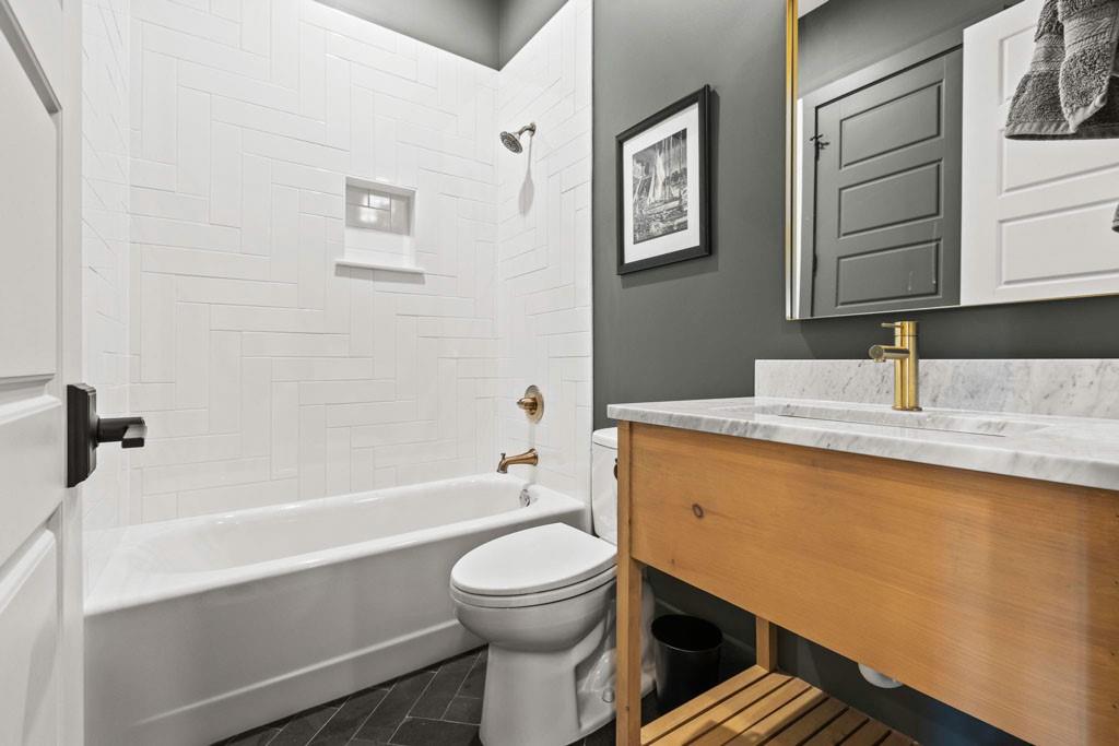 1412 Carroll Drive Northwest Atlanta, GA 30318 - Photo 15 of 42 a bathroom with a granite countertop toilet sink and bathtub