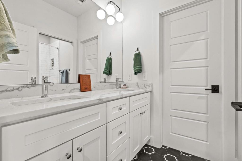 1412 Carroll Drive Northwest Atlanta, GA 30318 - Photo 22 of 42 a bathroom with a double vanity sink and a mirror