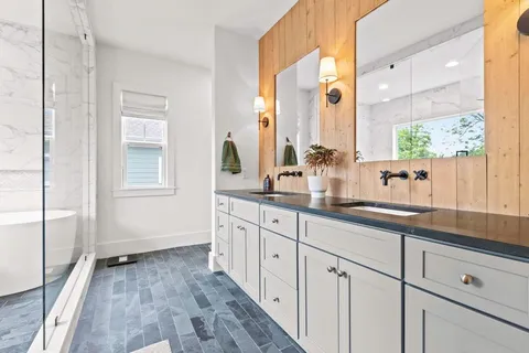 a bathroom with a white bath tub and a shower