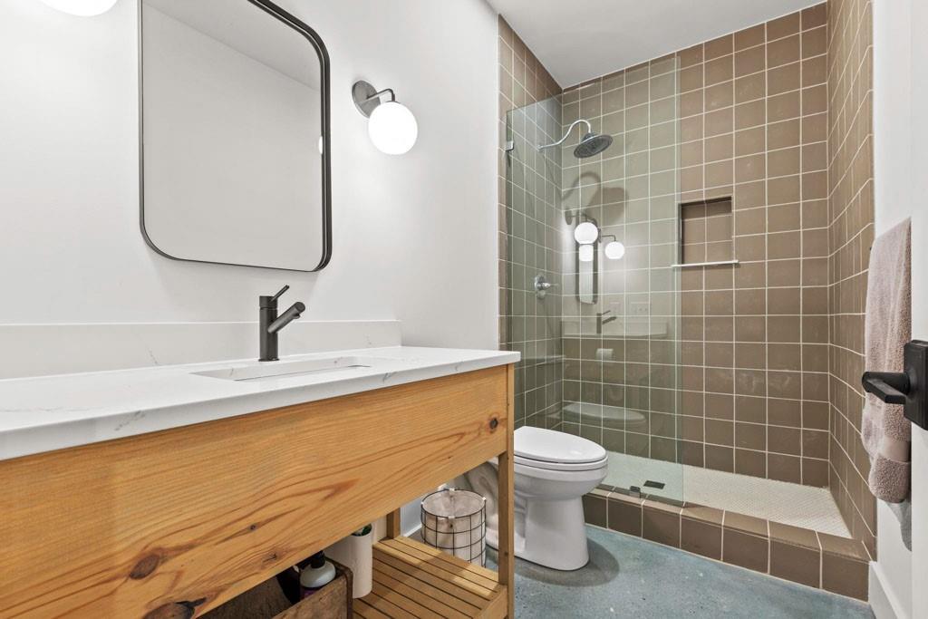 1412 Carroll Drive Northwest Atlanta, GA 30318 - Photo 31 of 42 a bathroom with a sink a toilet and shower