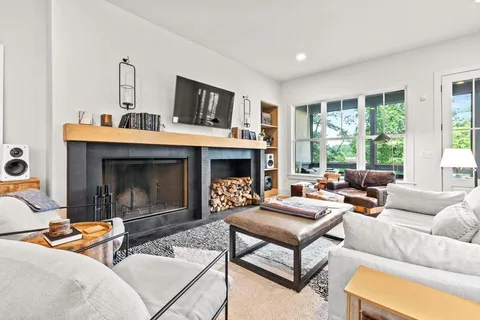 a living room with furniture and wooden floor