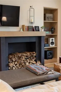 a living room with furniture and a dining table with kitchen view