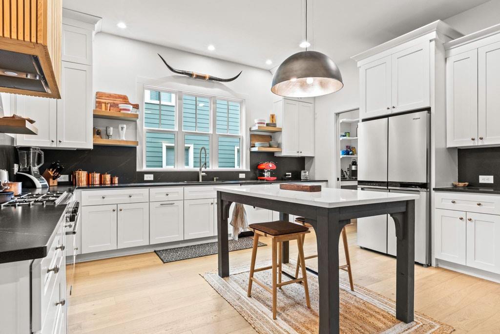 1412 Carroll Drive Northwest Atlanta, GA 30318 - Photo 10 of 42 a kitchen with stainless steel appliances granite countertop a table chairs sink and cabinets