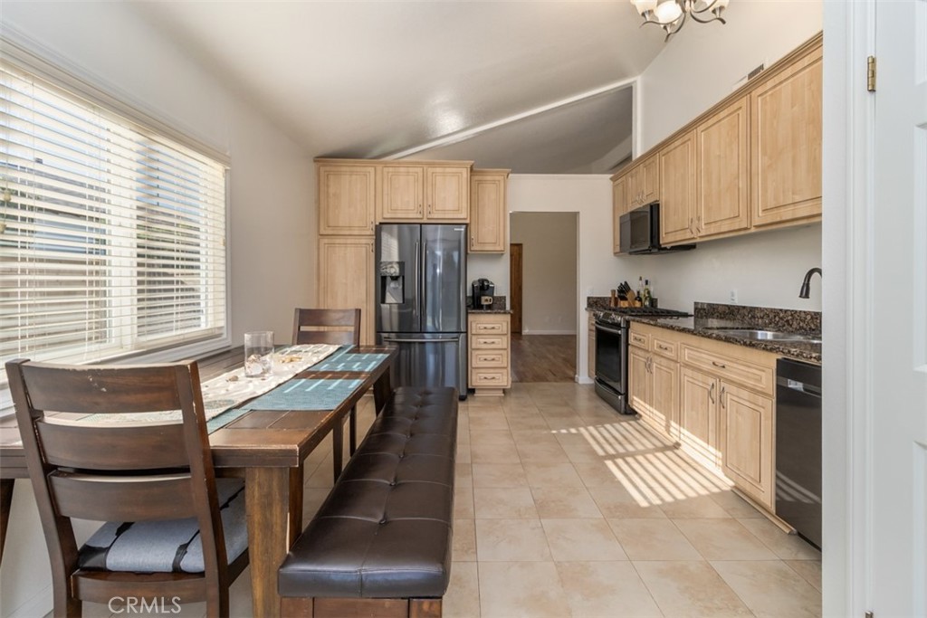 27432 Pinavete Mission Viejo, CA 92691 - Photo 12 of 37 a kitchen with stainless steel appliances granite countertop a refrigerator a stove a sink dishwasher and white cabinets with wooden floor