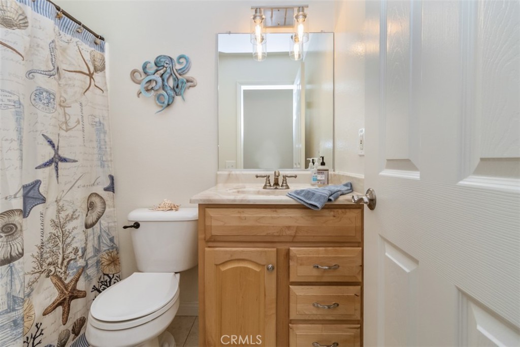 27432 Pinavete Mission Viejo, CA 92691 - Photo 26 of 37 a bathroom with a granite countertop toilet sink and mirror