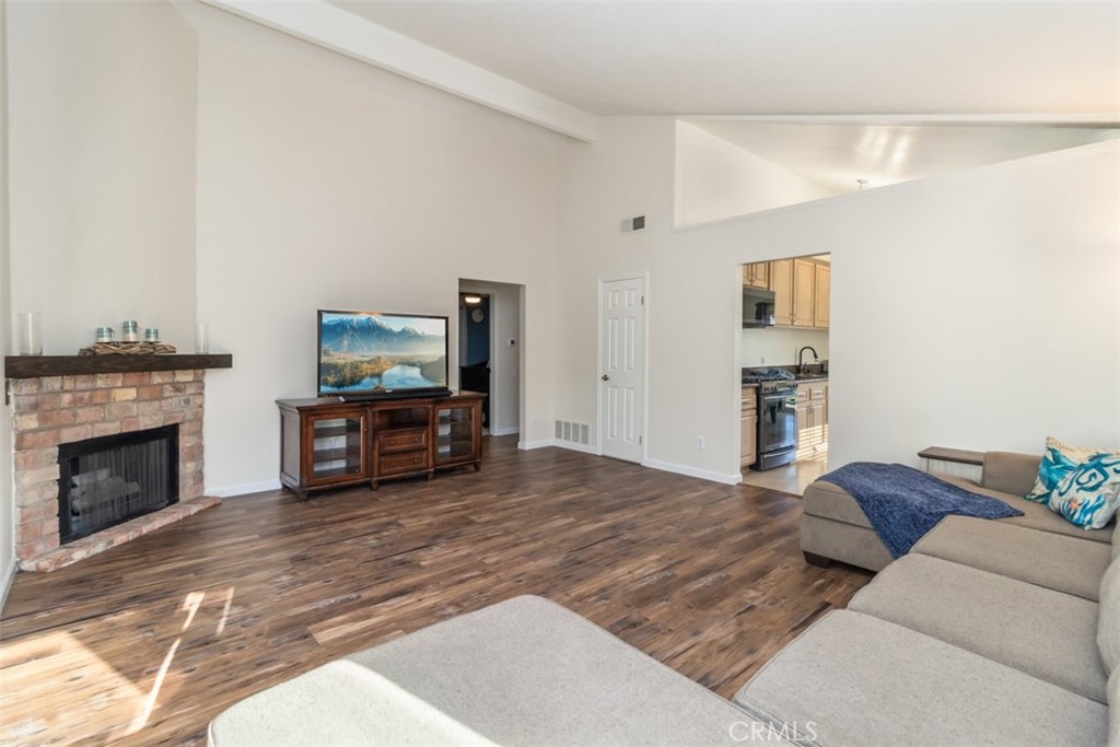 27432 Pinavete Mission Viejo, CA 92691 - Photo 9 of 37 a living room with furniture a fireplace and a flat screen tv
