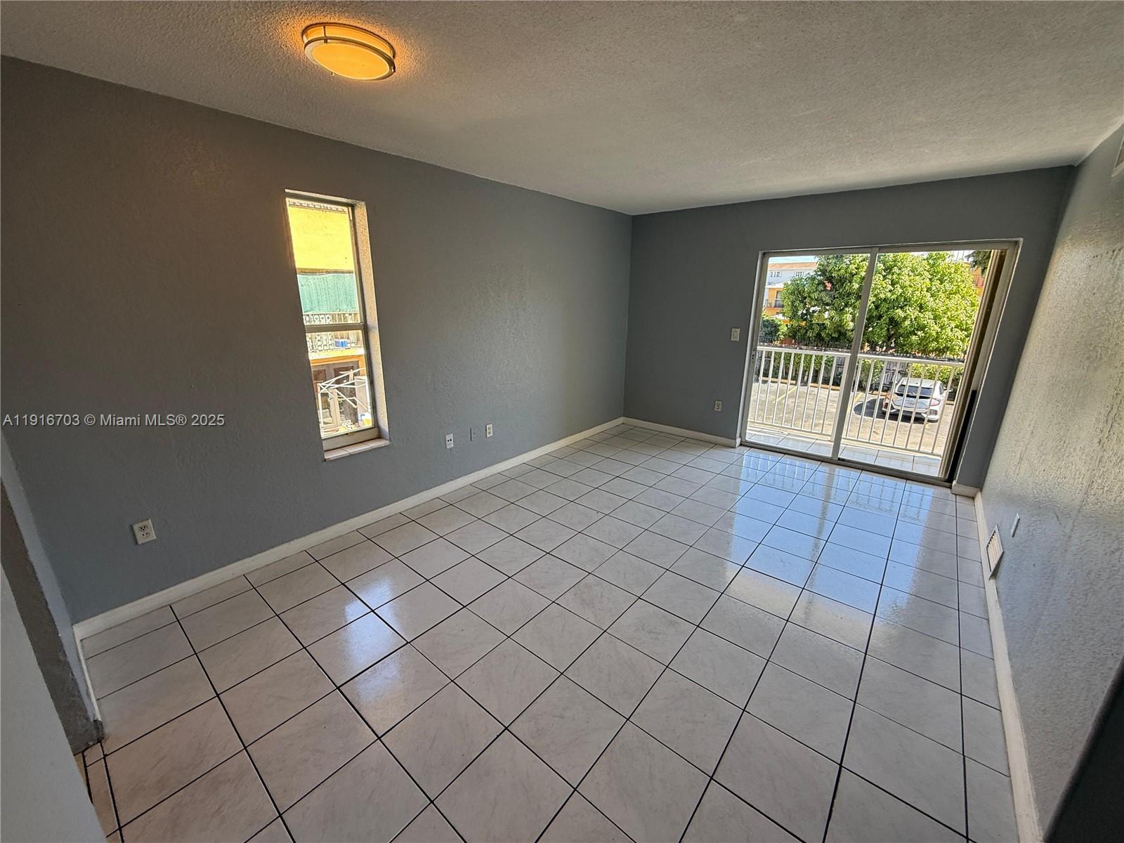 1255 West 49th Place, Unit B201 Hialeah, FL 33012 - Photo 2 of 11 a view of an empty room and window