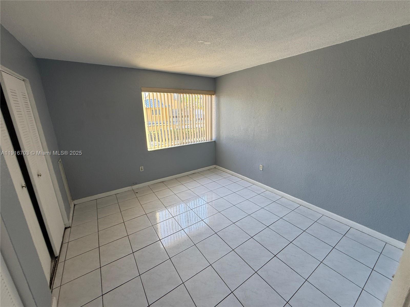 1255 West 49th Place, Unit B201 Hialeah, FL 33012 - Photo 5 of 11 a view of an empty room and window