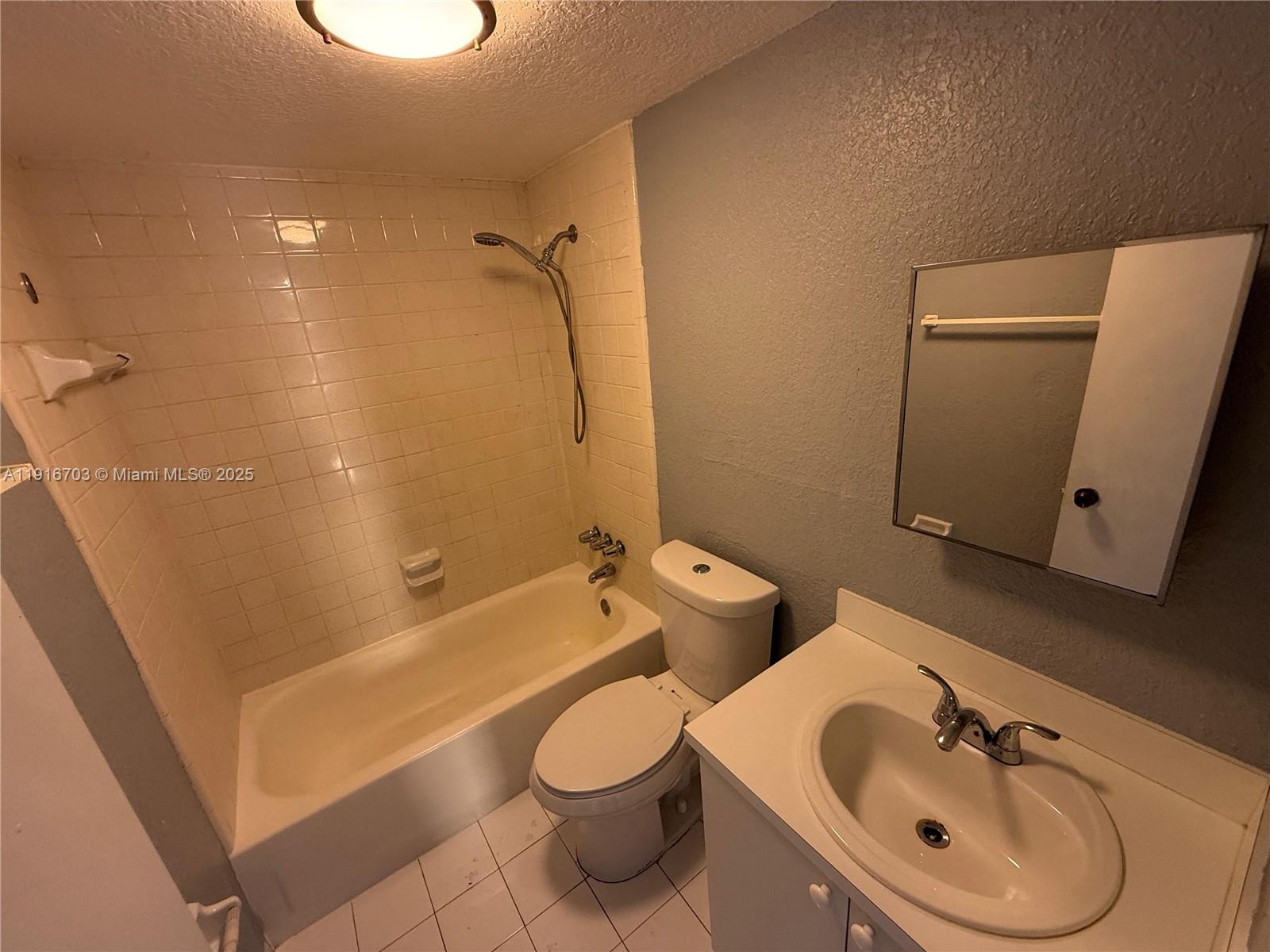 1255 West 49th Place, Unit B201 Hialeah, FL 33012 - Photo 6 of 11 a bathroom with a sink a toilet and shower