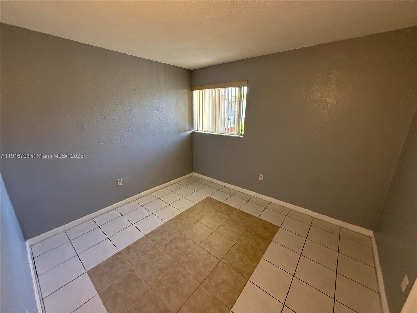1255 West 49th Place, Unit B201 Hialeah, FL 33012 - Photo 7 of 11 an empty room with windows