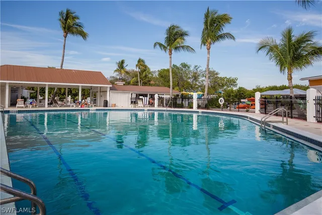 a view of swimming pool with outdoor seating and city view
