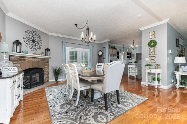 a view of a dining room with furniture a rug and wooden floor