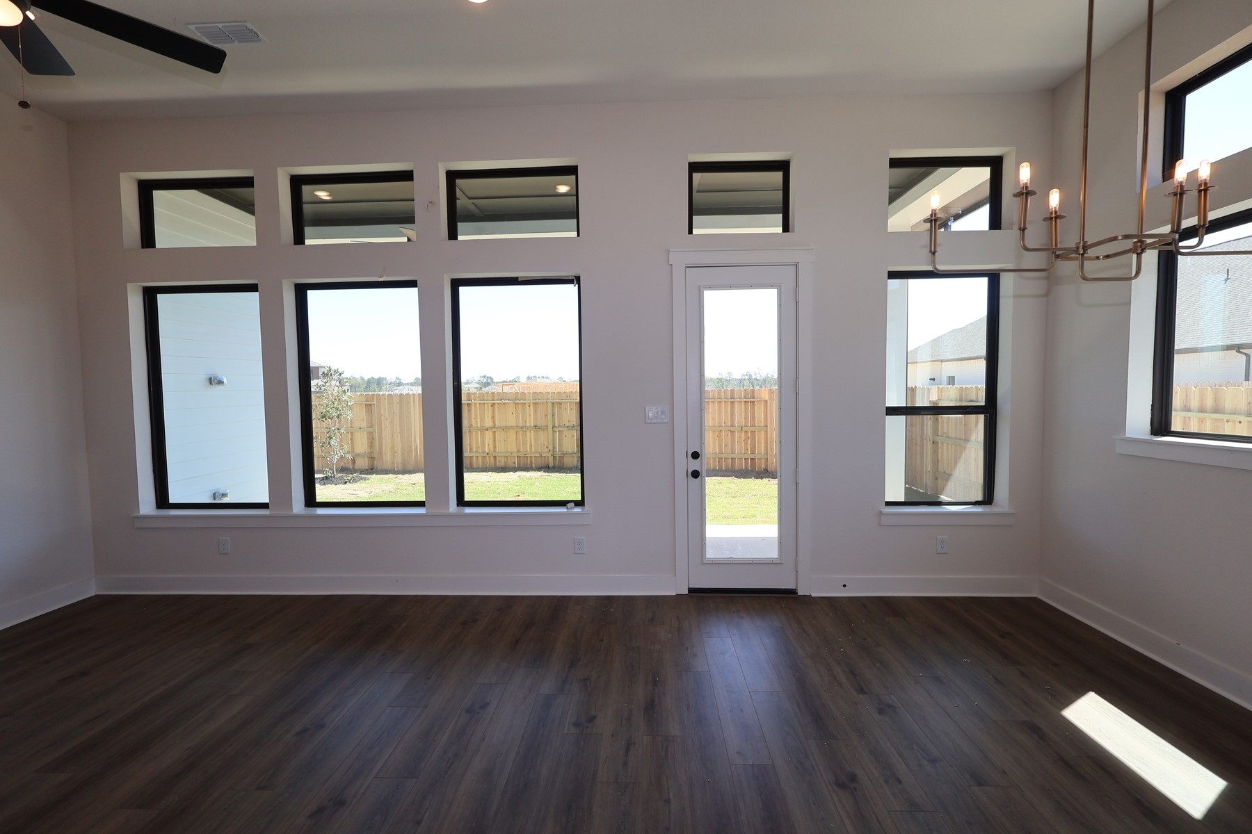 18607 Rumba Court Conroe, TX 77302 - Photo 7 of 20 a view of an empty room with wooden floor and a window