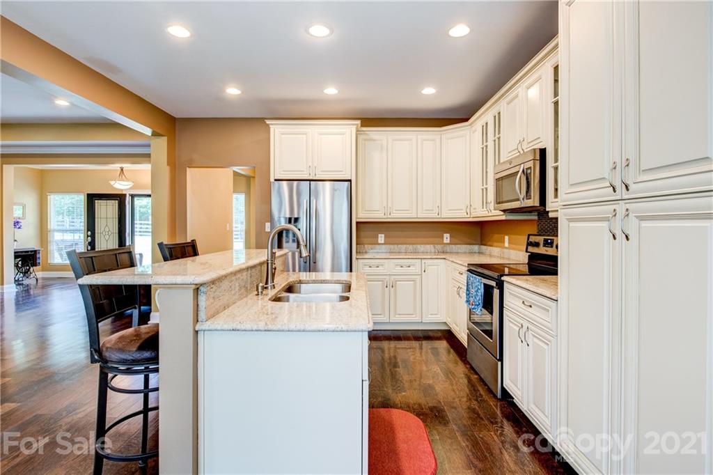 1637 State Rd S-46-1102, Unit 4 York, SC 29745 - Photo 14 of 39 a kitchen with white cabinets and stainless steel appliances