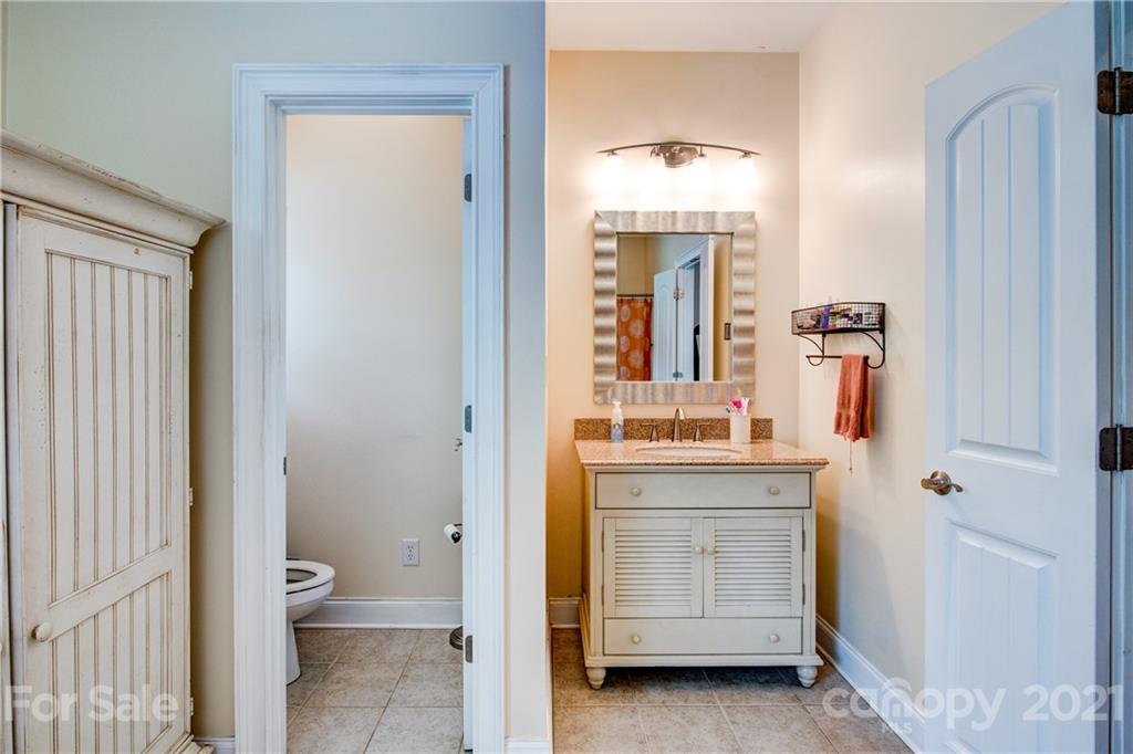 1637 State Rd S-46-1102, Unit 4 York, SC 29745 - Photo 21 of 39 a bathroom with a double vanity sink and mirror
