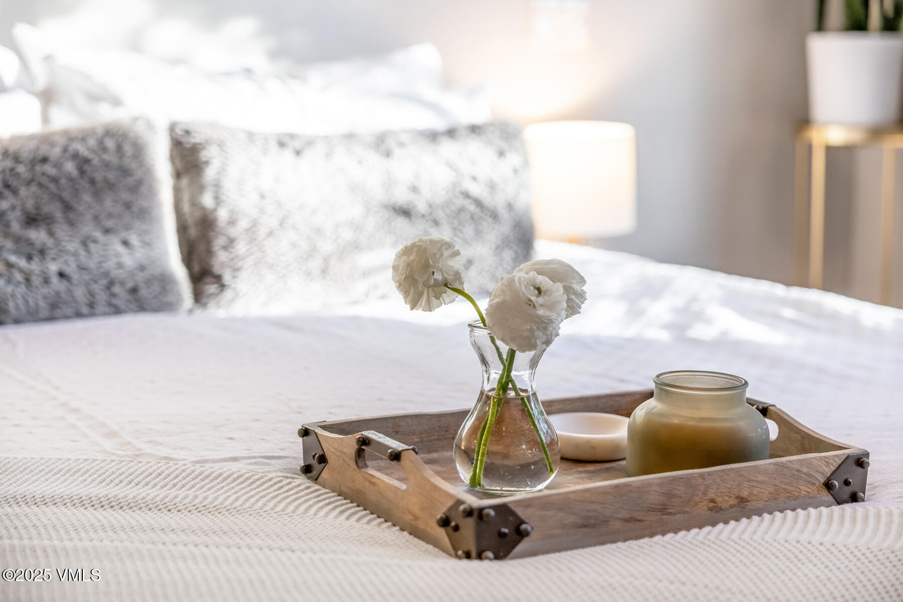 2310 Old Trail Road, Unit A Avon, CO 81620 - Photo 14 of 36 a bedroom with a bed and a chandelier