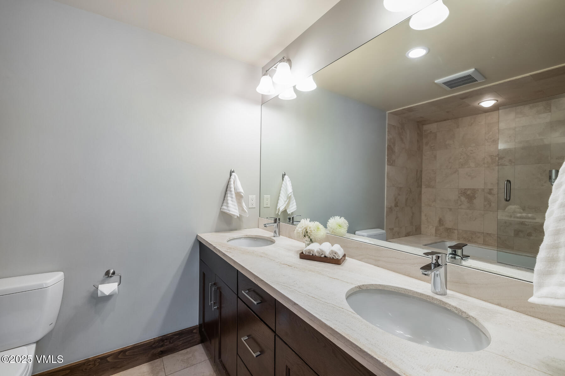 2310 Old Trail Road, Unit A Avon, CO 81620 - Photo 15 of 36 a bathroom with a sink a toilet and a mirror